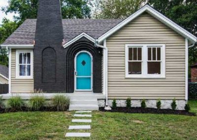 Black Brick Chimney & Home Exterior With Blue Accent Door